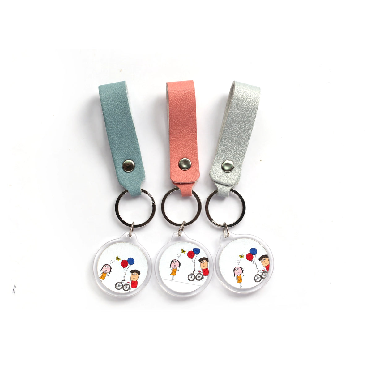 Three leather strap photo keychains with cartoon artwork on acrylic discs